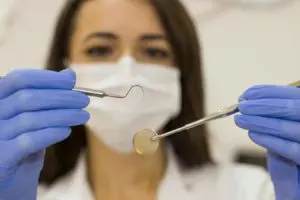 dental assistant holding tools