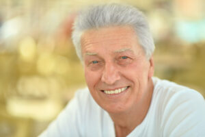 older man with healthy smile dentures oral health